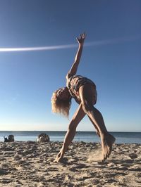 Full length of person on beach against clear sky