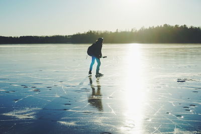 Full length of man standing on lake against sky