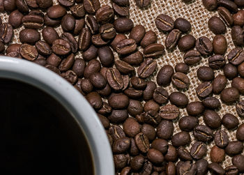 Close-up of coffee beans with cup