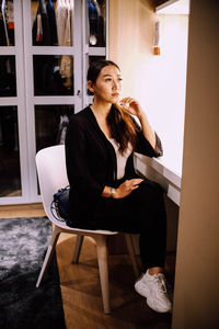 Young woman sitting on chair