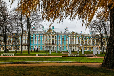 Built structure with bare trees in foreground