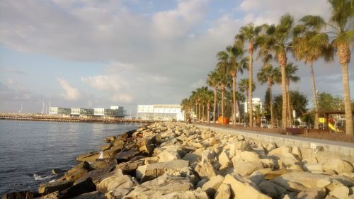 Panoramic shot of city by sea against sky