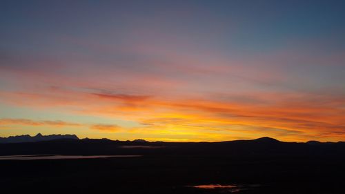 Silhouette landscape against scenic sky