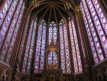 Low angle view of ornate glass window of building