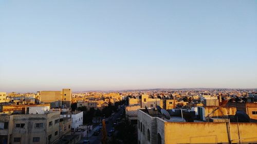 Cityscape against clear sky during sunset