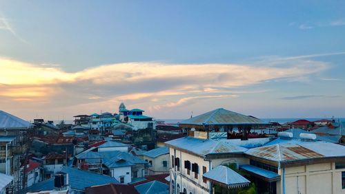 High angle view of houses in town against sky