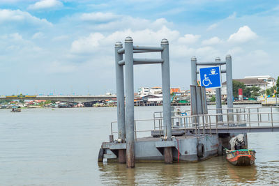 Boats moored on river against sky