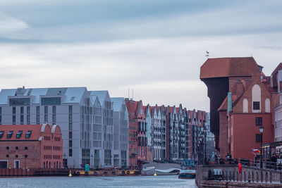 City street by buildings against sky