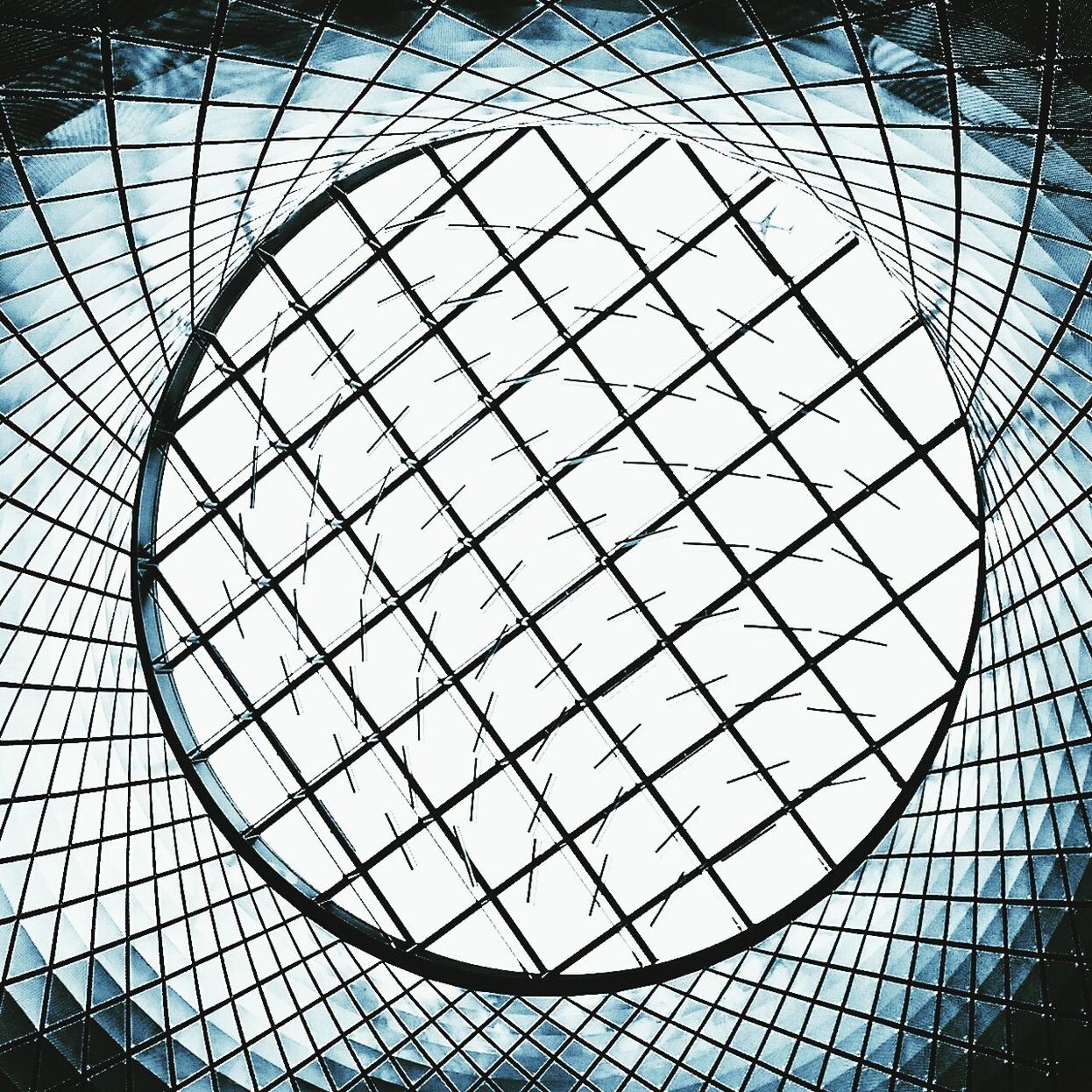 pattern, glass - material, architecture, geometric shape, indoors, design, low angle view, built structure, modern, ceiling, architectural feature, full frame, backgrounds, shape, skylight, circle, transparent, repetition, reflection, no people