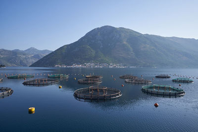 High angle view of sea and mountains against clear sky