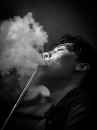 Close-up of man smoking hookah