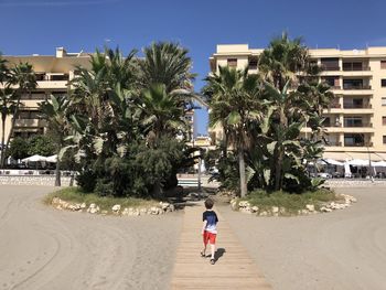 Rear view of woman walking on street