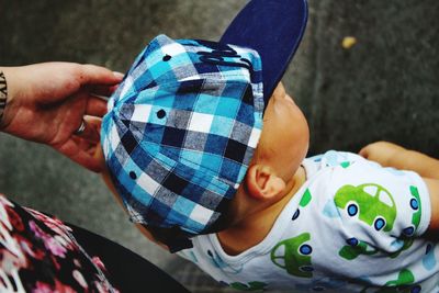 Close-up of boy with mother standing on road