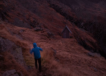 Rear view of man walking on mountain