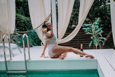 Woman relaxing in swimming pool