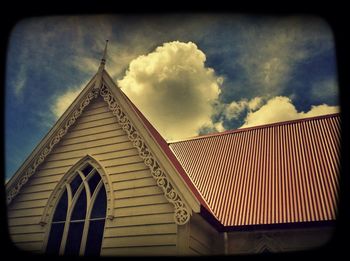 Low angle view of built structure against cloudy sky