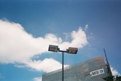 Low angle view of text on building against sky