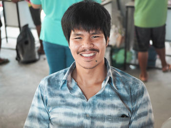 Portrait of smiling boy standing outdoors