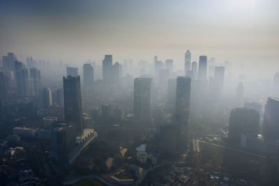 High angle view of modern buildings in city against sky