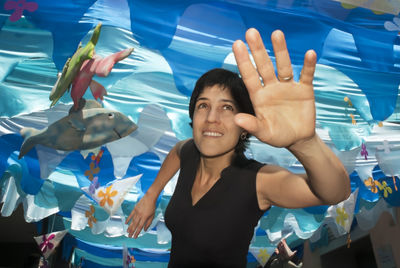 Portrait of smiling young woman standing in swimming pool