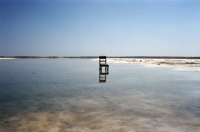 Lifeguard hut on beach against clear sky
