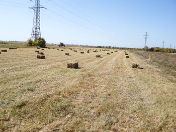 Electricity pylon on field against sky