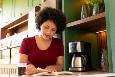 Young woman using mobile phone at home