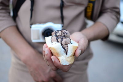 Midsection of man holding ice cream