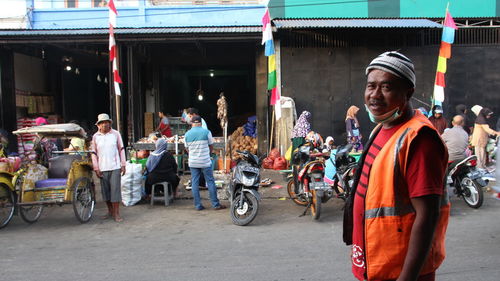 People riding motorcycle on road in city