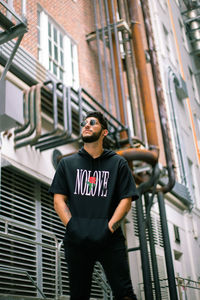 Full length of young man wearing sunglasses standing outdoors