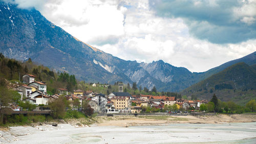 Barcis village with mountains in background and cloudy sky - pordenone