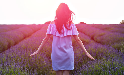 Close-up of woman with flowers on field