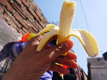 Close-up of hand eating fruit