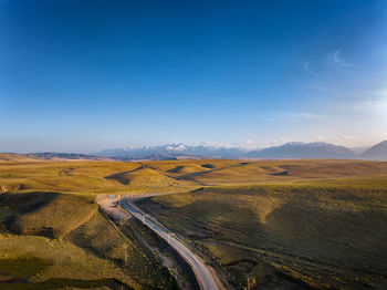 Road amidst landscape against sky