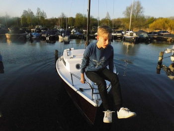 Rear view of man on boat sailing in lake