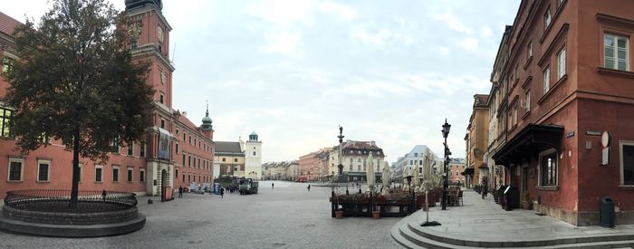 Panoramic view of city street against sky