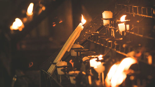 Close-up of candles burning in temple