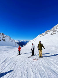 People skiing on snow covered landscape