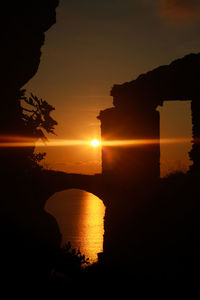 Scenic view of sea against orange sky