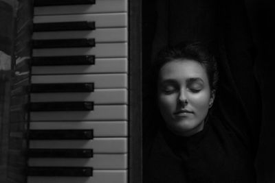 Portrait of woman laying on the floor near piano