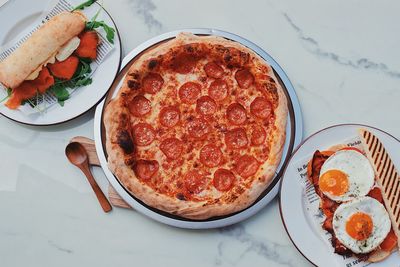 High angle view of pizza served on table