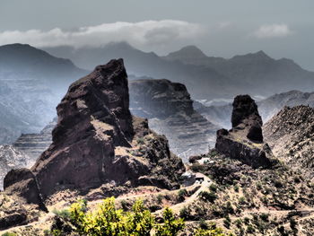 Scenic view of sea and mountains against sky