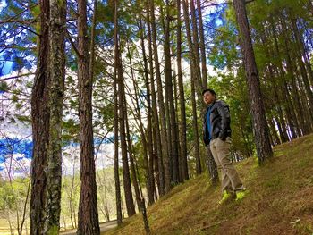 Man and dog walking in forest