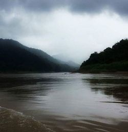 Scenic view of lake against cloudy sky