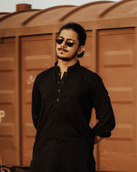 Young man wearing sunglasses standing outdoors