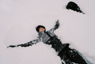 Low section of woman skiing on snow covered field