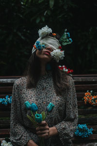 Portrait of woman holding flowers