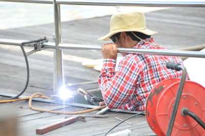 Full length of young woman sitting on boat