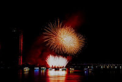 Low angle view of firework display at night