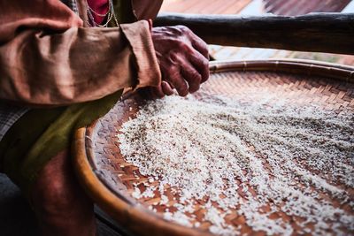 Midsection of woman with rice in plate